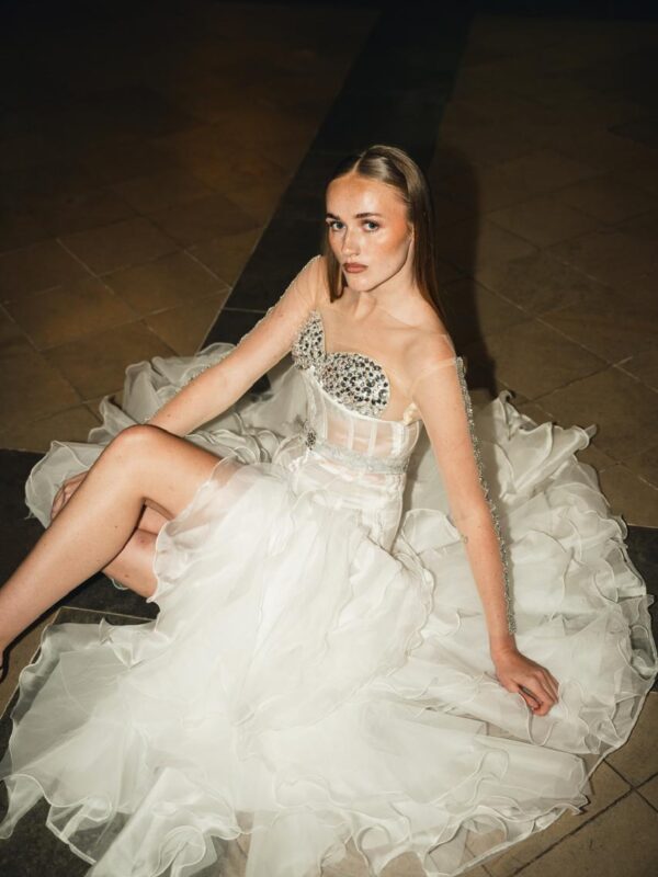 White structured corset gown with layered ruffle skirt from Cloud Devotion collection by Saanjh by Saloni, runway editorial inside church