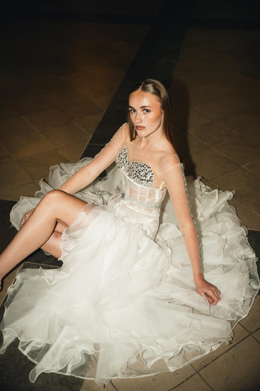 White structured corset gown with layered ruffle skirt from Cloud Devotion collection by Saanjh by Saloni, runway editorial inside church