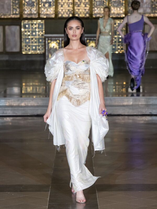 Model wearing ivory and gold hand-embroidered draped set with sculpted sheer sleeves from Cloud Devotion by Saanjh by Saloni at London Fashion Week 2026.